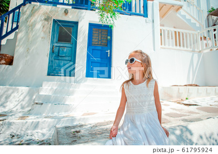 Adorable little girl at old street of typical greek traditional village Adorable little girl at old street of typical greek traditional village 61795924