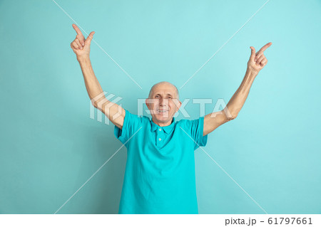 Caucasian senior man's portrait isolated on blue studio background 61797661