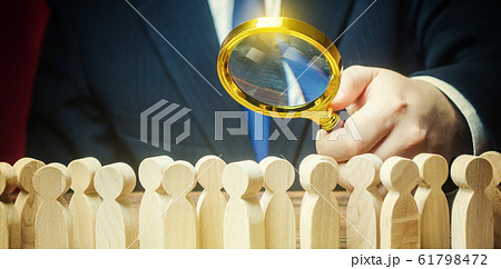 Businessman is studying a crowd of people with a magnifying glass. Hr search candidates for work, staff recruiting. Society, demographic. Market and customers research. Citizens electorate. Sociology Businessman is studying a crowd of people with a magnifying glass. Hr search candidates for work, staff recruiting. Society, demographic. Market and customers research. Citizens electorate. Sociology 61798472