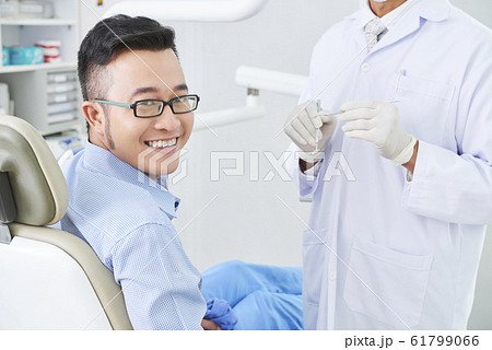 Happy Asian Patient At Dentist's 61799066