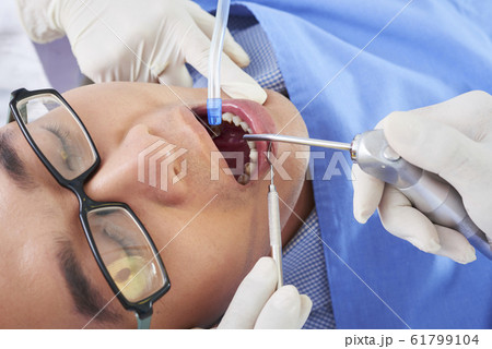 Asian Man On Dentist Chair Asian Man On Dentist Chair 61799104