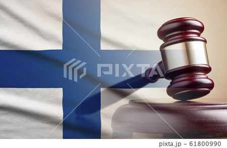 Lawyers wooden gavel over the flag of Finland Lawyers wooden gavel over the flag of Finland 61800990