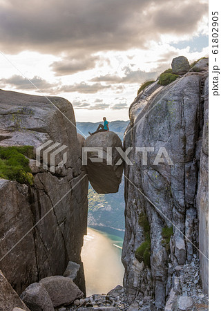 Woman tourist on Kjeragbolten Travel Norway Kjerag mountains Woman tourist on Kjeragbolten Travel Norway Kjerag mountains 61802905