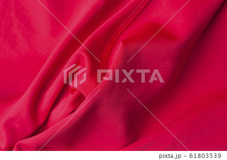 Fragment of crumpled red polyester fabric Fragment of crumpled red polyester fabric 61803539