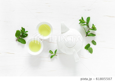 Green mint tea with fresh leaves in cups and 61805507