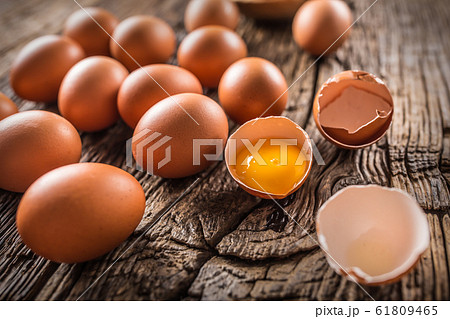 Fresh raw eggs on rustic wooden table Fresh raw eggs on rustic wooden table 61809465
