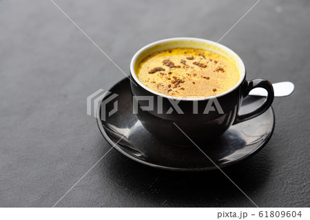 Serving of aromatic turmeric black coffee against 61809604