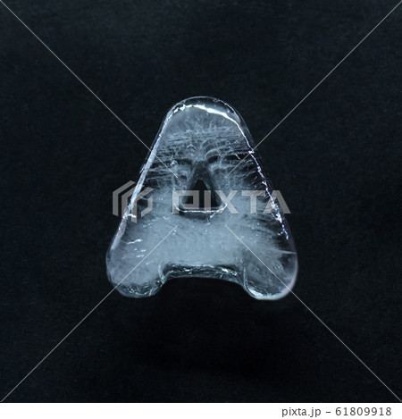 Alphabet's letters made out of ice isolated on dark studio background Alphabet's letters made out of ice isolated on dark studio background 61809918