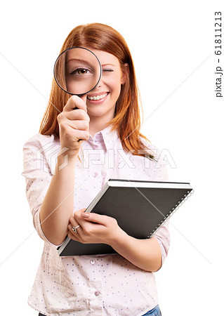 Young student girl looking through a magnifying Young student girl looking through a magnifying 61811213