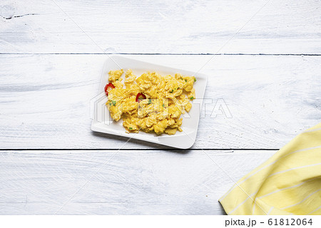 Scrambled eggs on plate and white table. Tasty Scrambled eggs on plate and white table. Tasty 61812064