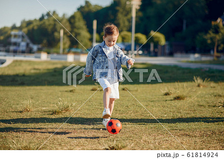 Cute little child playing in a summer park 61814924