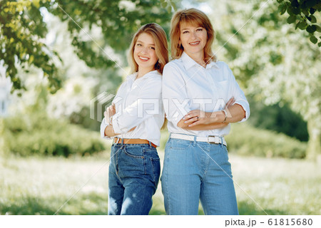 Mother with young daughter in a summer park Mother with young daughter in a summer park 61815680