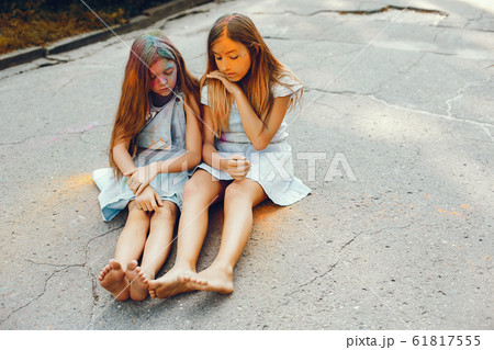 Two cute girls have fun in a summer park 61817555