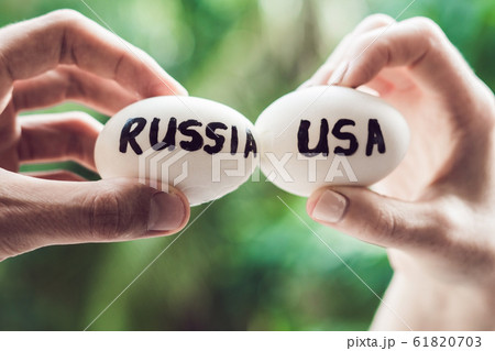 Eggs with the inscriptions of Russia and the United States, fight, who are broken. conflict between USA vs Russia, governments conflict concept 61820703