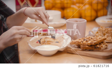 A woman cutting a pancake in the plate A woman cutting a pancake in the plate 61821716