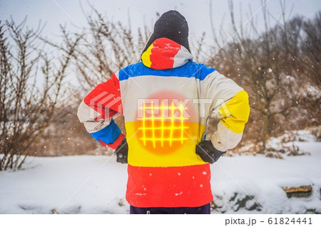 A man in a heated winter jacket. Under the jacket heating elements 61824441