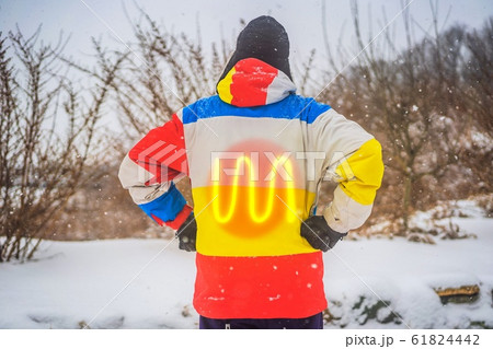 A man in a heated winter jacket. Under the jacket heating elements A man in a heated winter jacket. Under the jacket heating elements 61824442