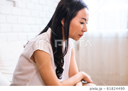 Sad thoughtful Asian female at home Sad thoughtful Asian female at home 61824490
