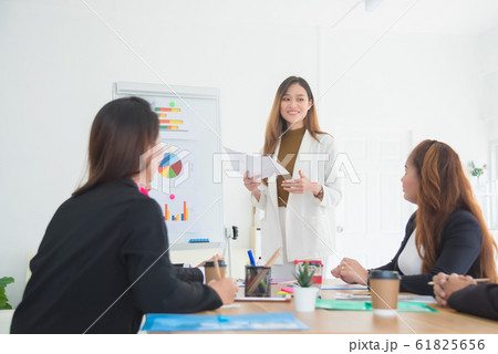 Beautiful asian business woman showing graph and diagram during presentation at meeting in office. 61825656