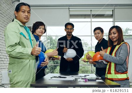 Group of construction team standing and show thumb up to agree project during meeting Group of construction team standing and show thumb up to agree project during meeting 61829151