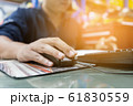Man is using the computer to work. 61830559