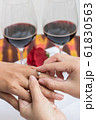 Couple wearing wedding ring 61830563