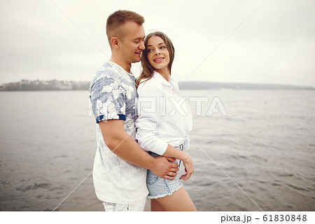 Beautiful couple spend time in a autumn cloudy park Beautiful couple spend time in a autumn cloudy park 61830848