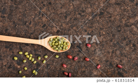 close up of green bean in wooden spoon with red beans  61831814