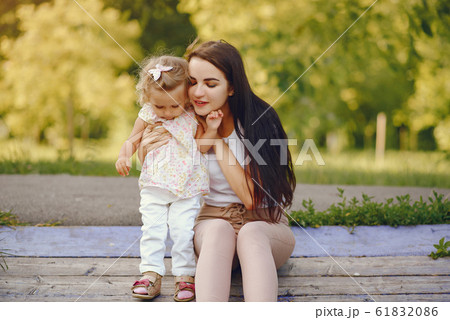 Mother with daughter playing in a summer park Mother with daughter playing in a summer park 61832086