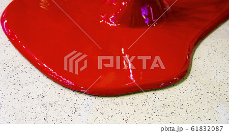 Bloody red paint spilled on cream coloured carpet 61832087