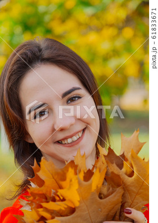 Beautiful happy woman with a bouquet of yellow 61833671
