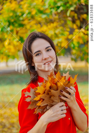 Beautiful happy woman with a bouquet of yellow 61833688