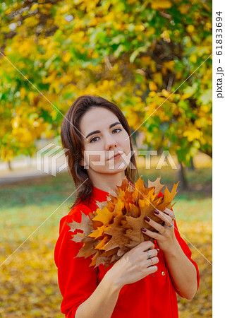 Beautiful happy woman with a bouquet of yellow 61833694