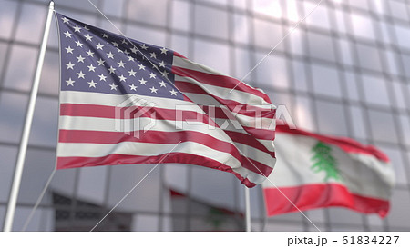 Waving flags of the USA and Lebanon in front of a modern skyscraper. 3D rendering Waving flags of the USA and Lebanon in front of a modern skyscraper. 3D rendering 61834227