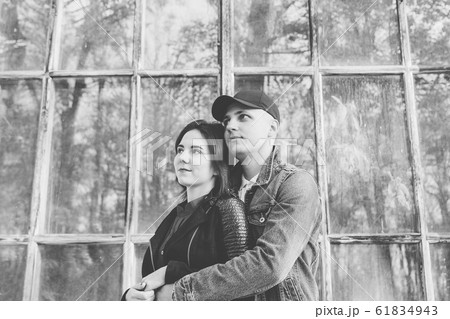 Happy lovers by the window in the park in autumn 61834943