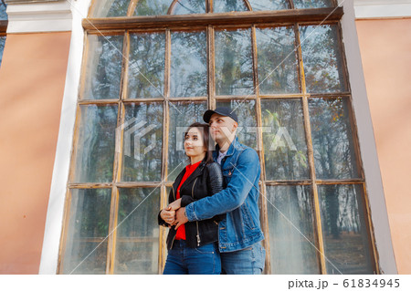Happy lovers by the window in the park in autumn 61834945