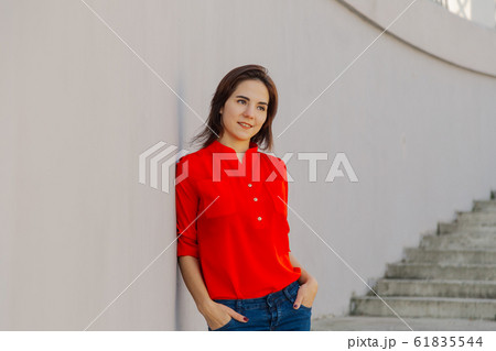Beautiful woman on a concrete staircase. Portrait 61835544