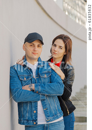 Happy lovers hug on a concrete staircase. 61835632