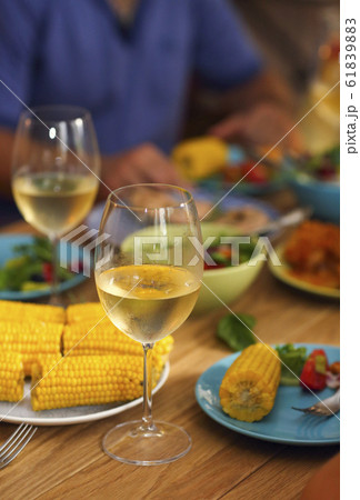 People cheering with white wine and rising glasses People cheering with white wine and rising glasses 61839883