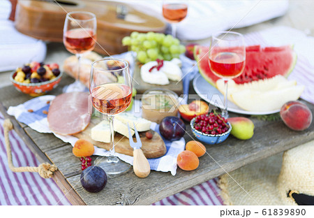 Picnic on the beach at sunset in the style of boho 61839890
