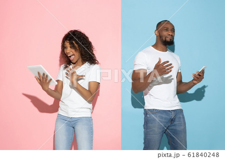 Young emotional man and woman on pink and blue background 61840248
