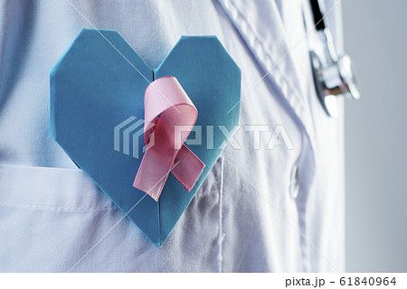 doctor with a blue heart and a pink ribbon 61840964