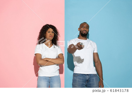 Young emotional man and woman on pink and blue background Young emotional man and woman on pink and blue background 61843178