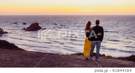 Romantic couple embracing each other during sunset at beach 61844164