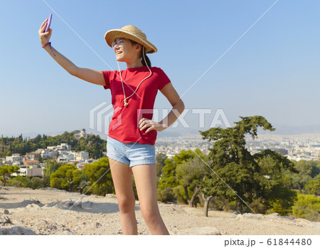 Girl is taking selfies in Athens, Greece Girl is taking selfies in Athens, Greece 61844480