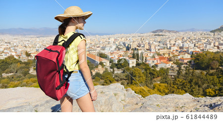 Girl is standing on hill and looking at Athens, 61844489