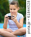 Girl is using smartphone 61844528