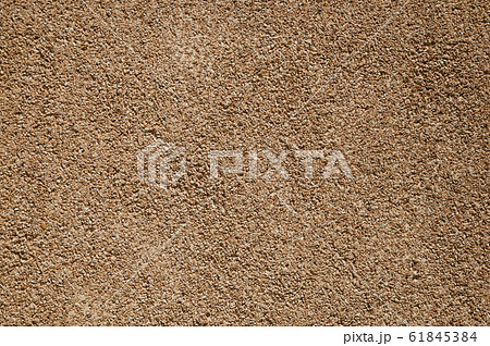 Close-up of wall with small gravel inserted into the plaster 61845384
