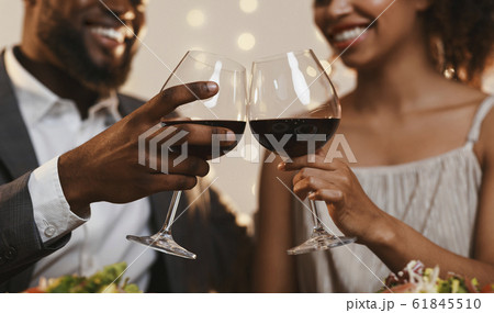 Close up of african couple toasting with red wine Close up of african couple toasting with red wine 61845510