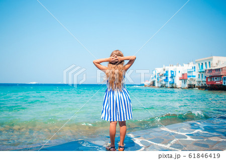 Adorable little girl at Little Venice the most popular tourist area on Mykonos island, Greece. 61846419